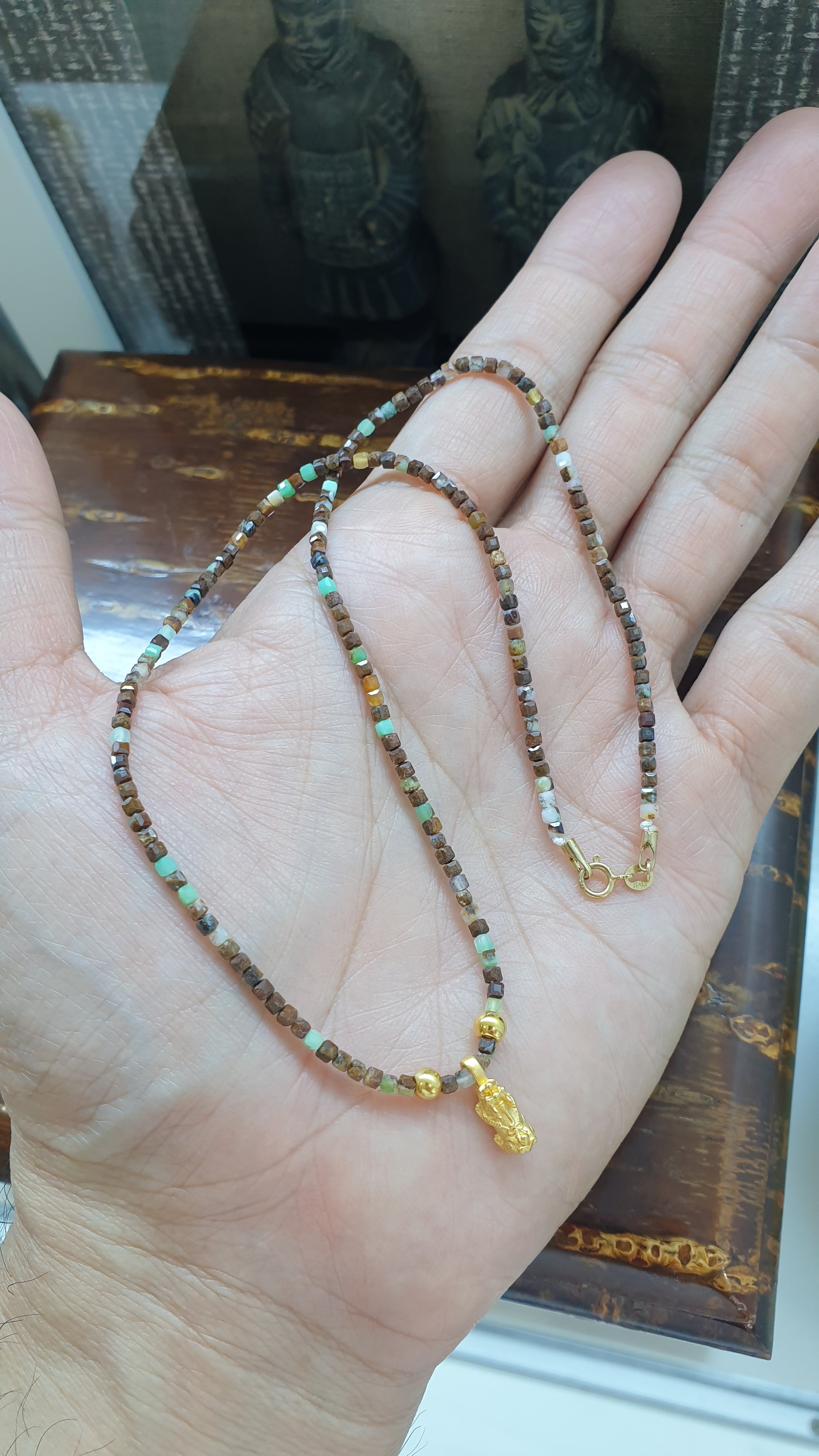 Close up of 24K Gold Mini Pixiu Charm on Gemstone Beaded Chain